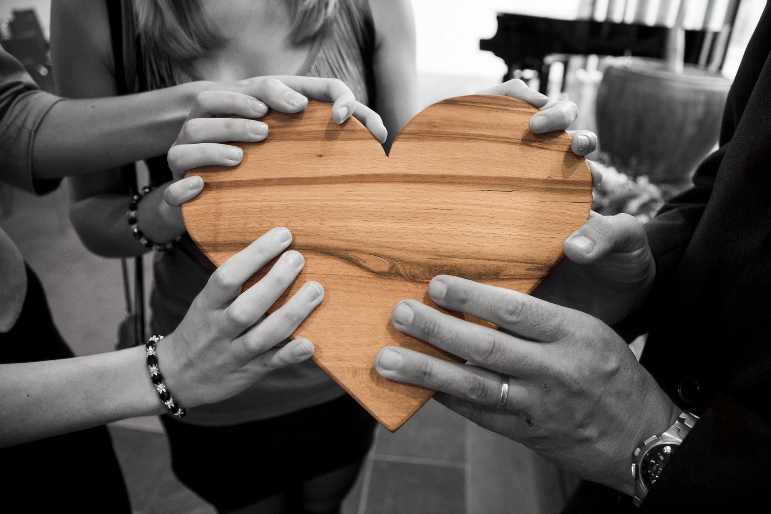 Selective Focus Photography of Group of Person Holding Wood Heart
